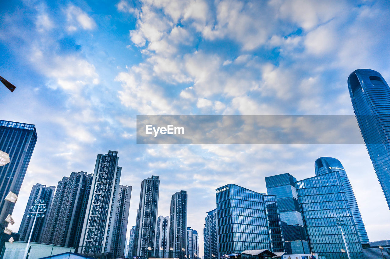 LOW ANGLE VIEW OF MODERN BUILDINGS AGAINST SKY IN CITY