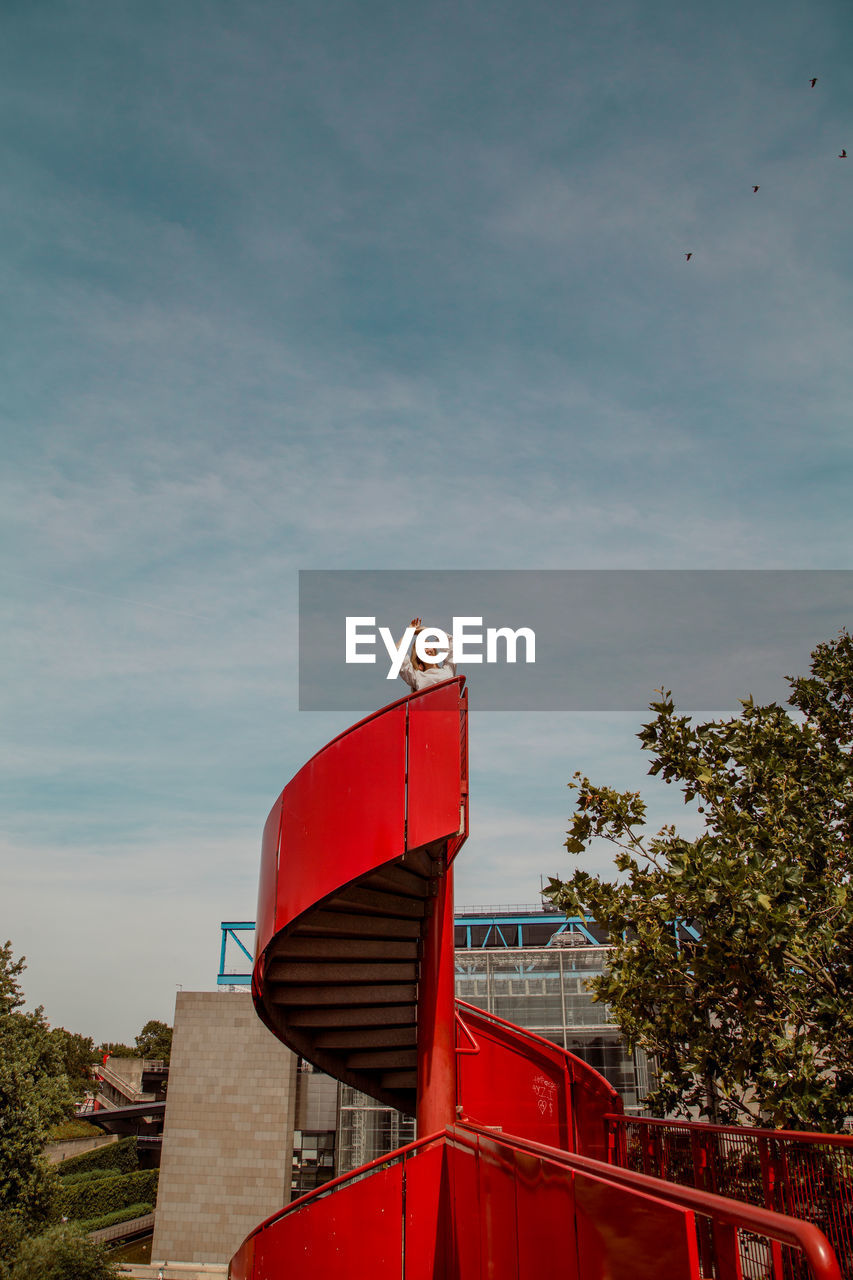 LOW ANGLE VIEW OF RED BIRD HOUSE