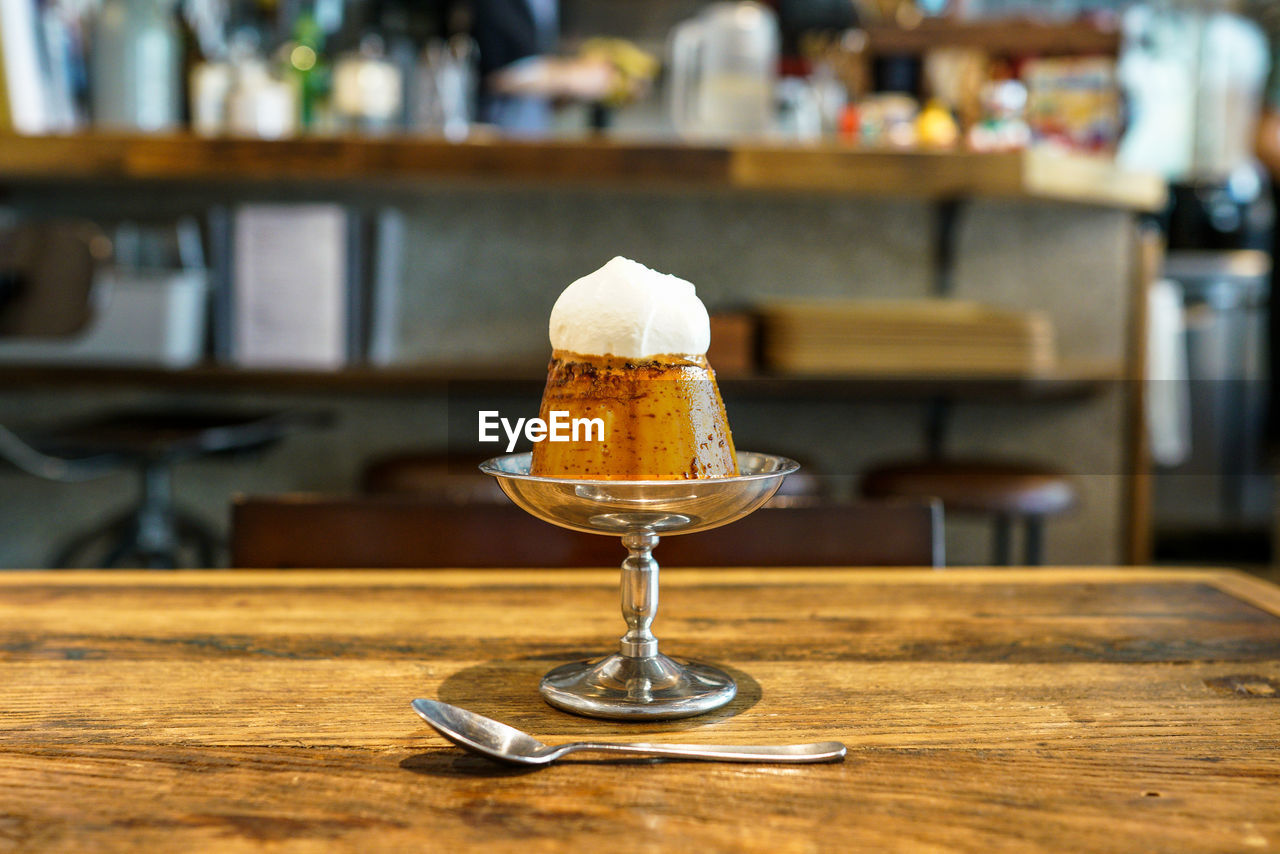 CLOSE-UP OF COCKTAIL IN GLASS ON TABLE