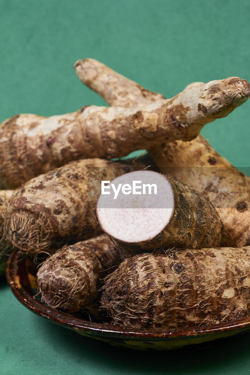 Closeup of taro root vegetable, eddo malanga, green background