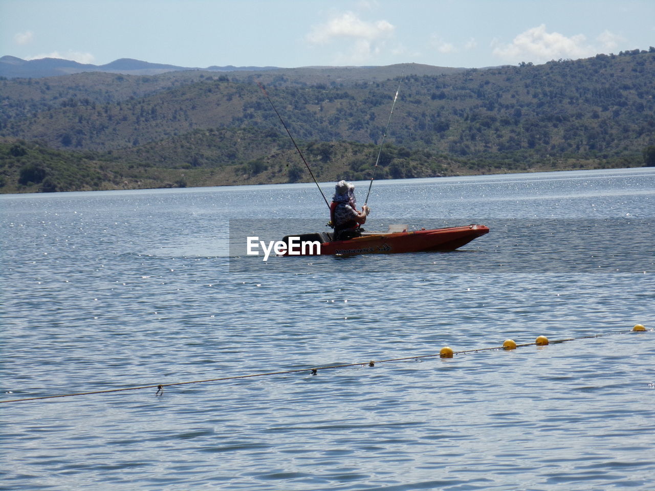 MAN ROWING BOAT IN RIVER