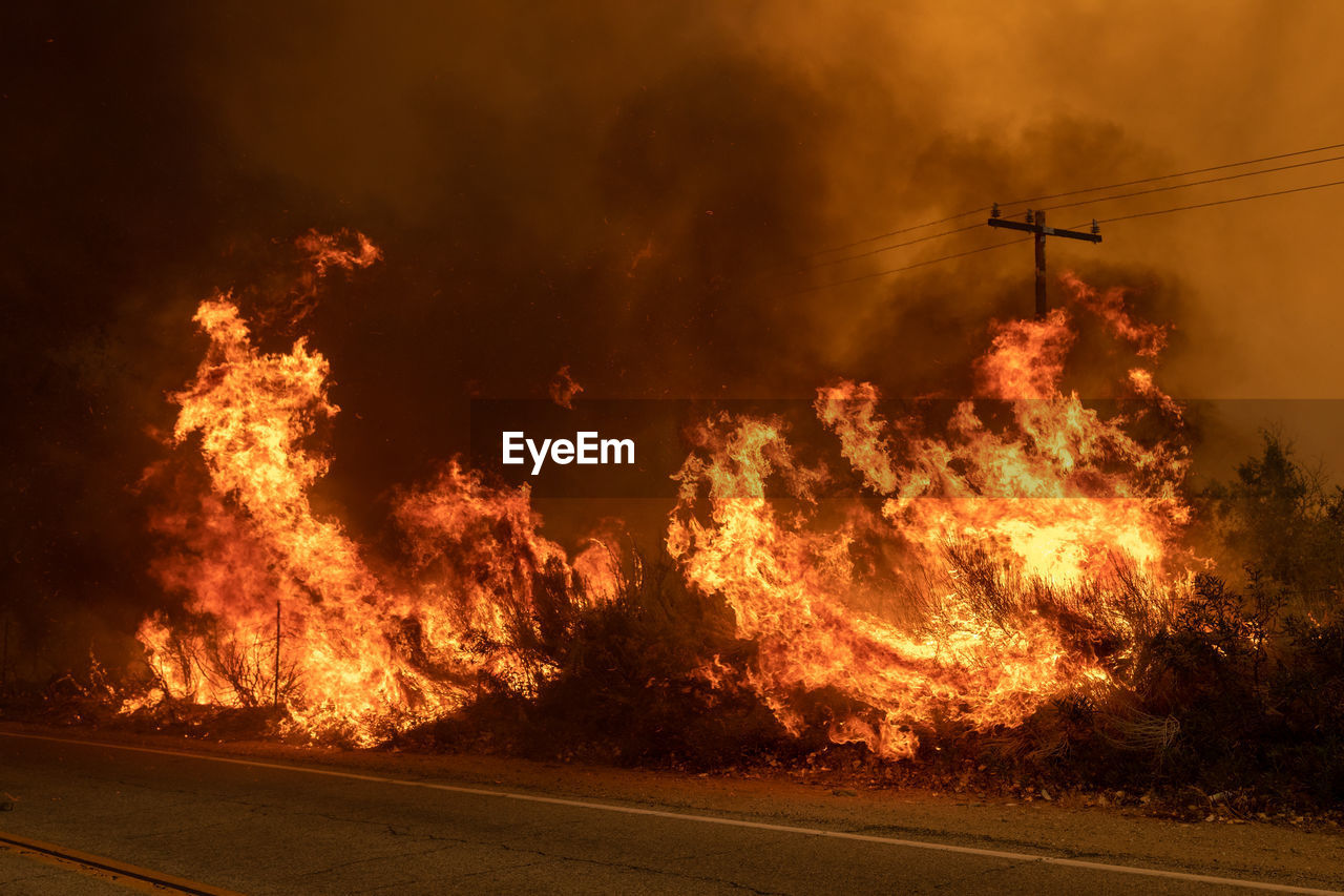 FIREWORK DISPLAY OVER ROAD AGAINST FIRE CRACKERS