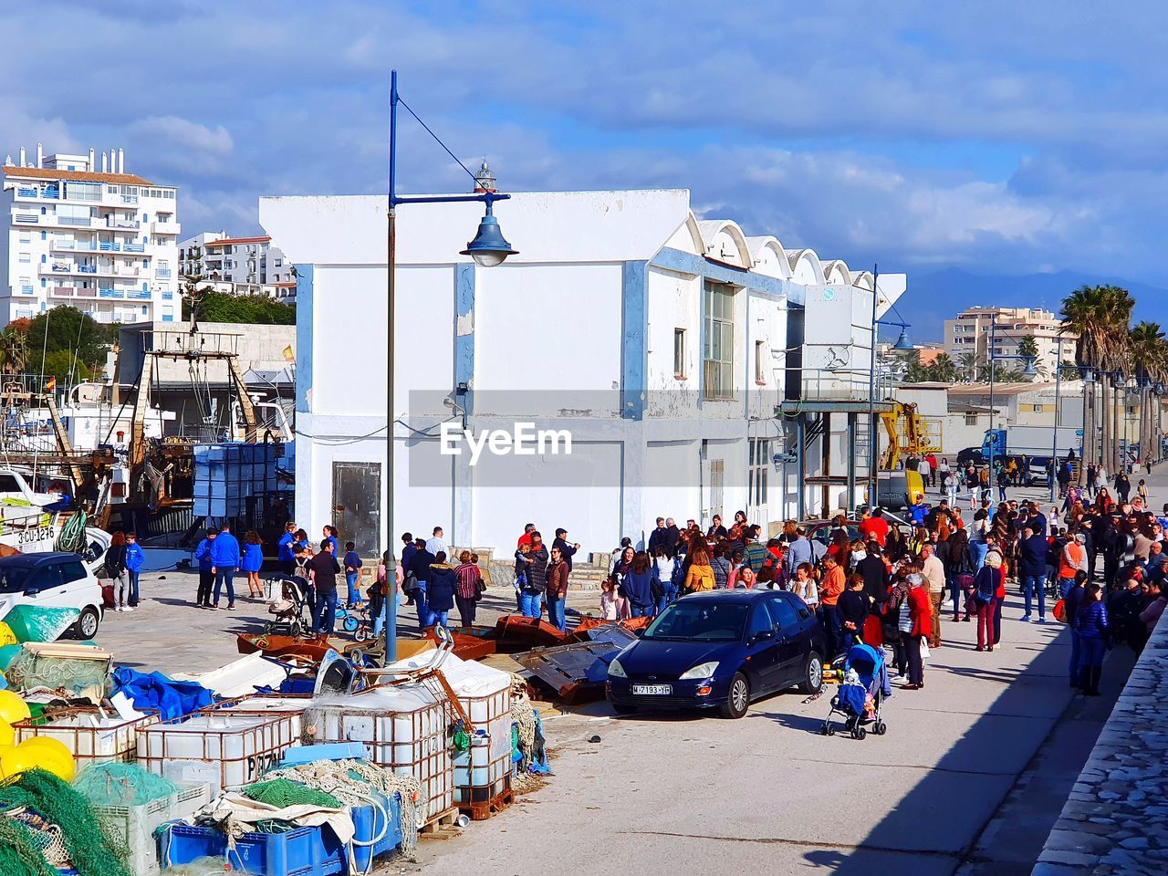 GROUP OF PEOPLE IN CITY AGAINST BUILDINGS IN SKY