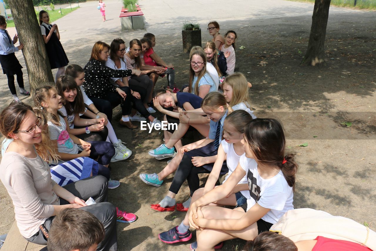 HIGH ANGLE VIEW OF PEOPLE LOOKING AT MEN