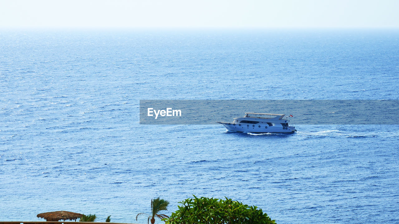 High angle view of ship sailing in sea against clear sky
