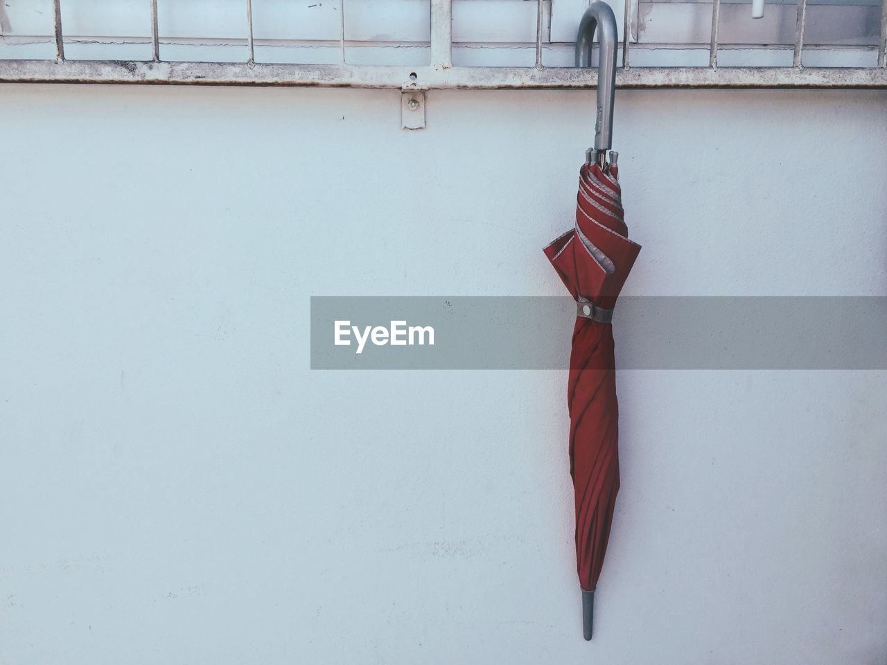 Close-up of umbrella hanging on wall