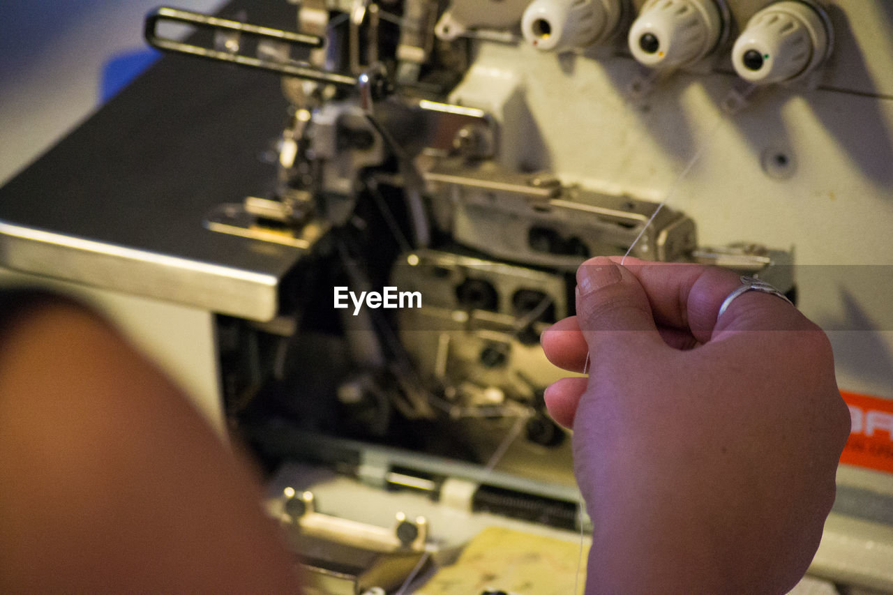 Cropped hands using sewing machine