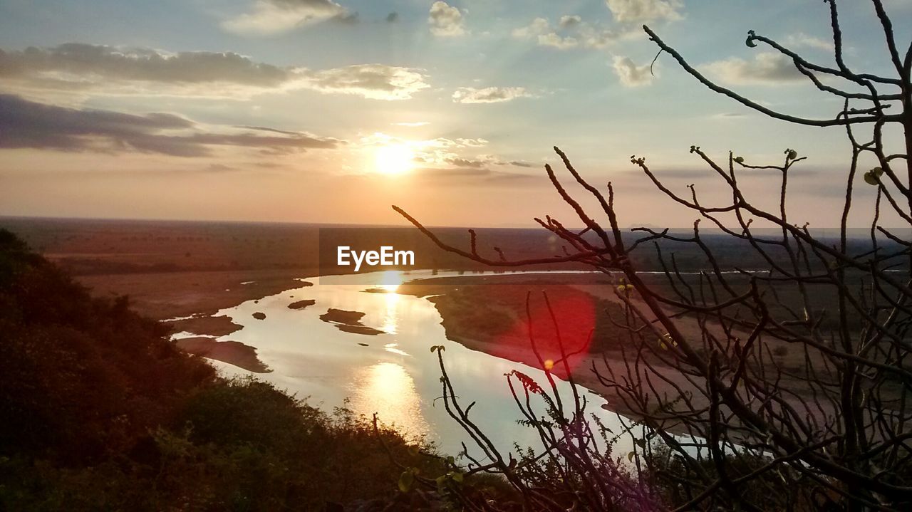 Scenic view of river against sky during sunset