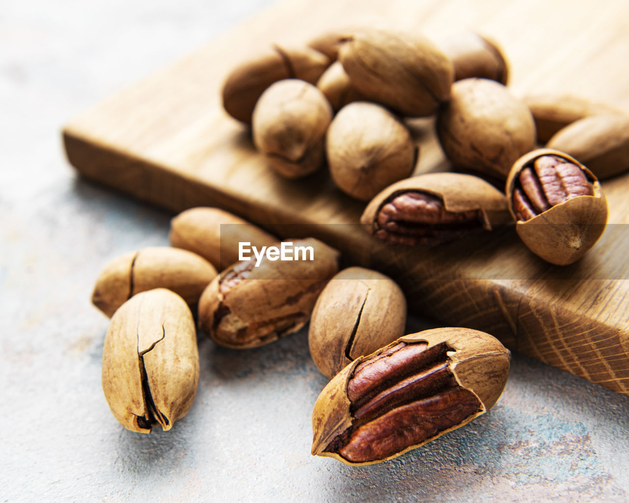 Pecan nuts on a grey concrete background