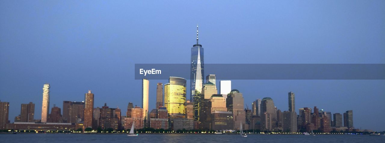 Modern buildings in city against clear sky