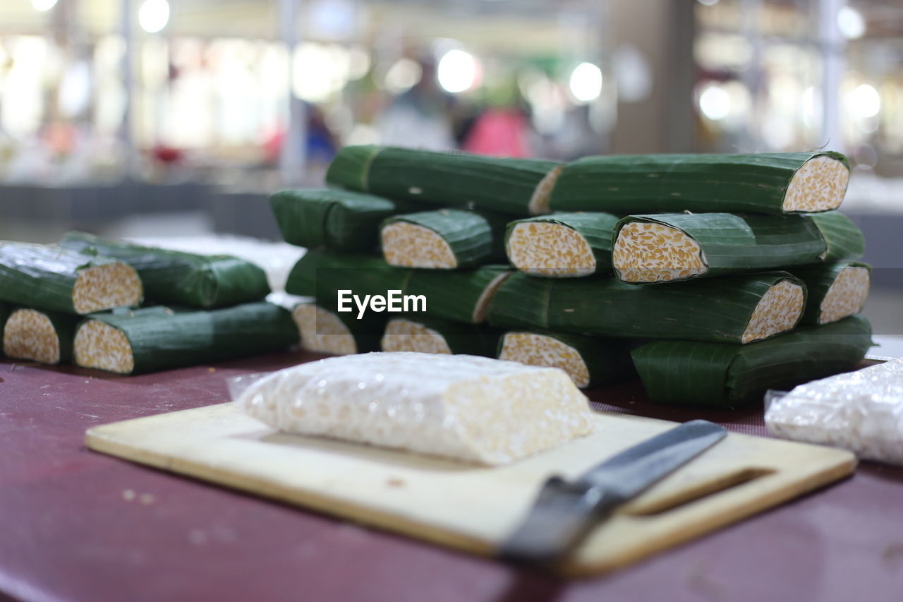 Close-up of food wrapped in banana leaves on wooden table