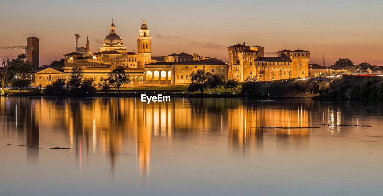 reflection of illuminated buildings in lake