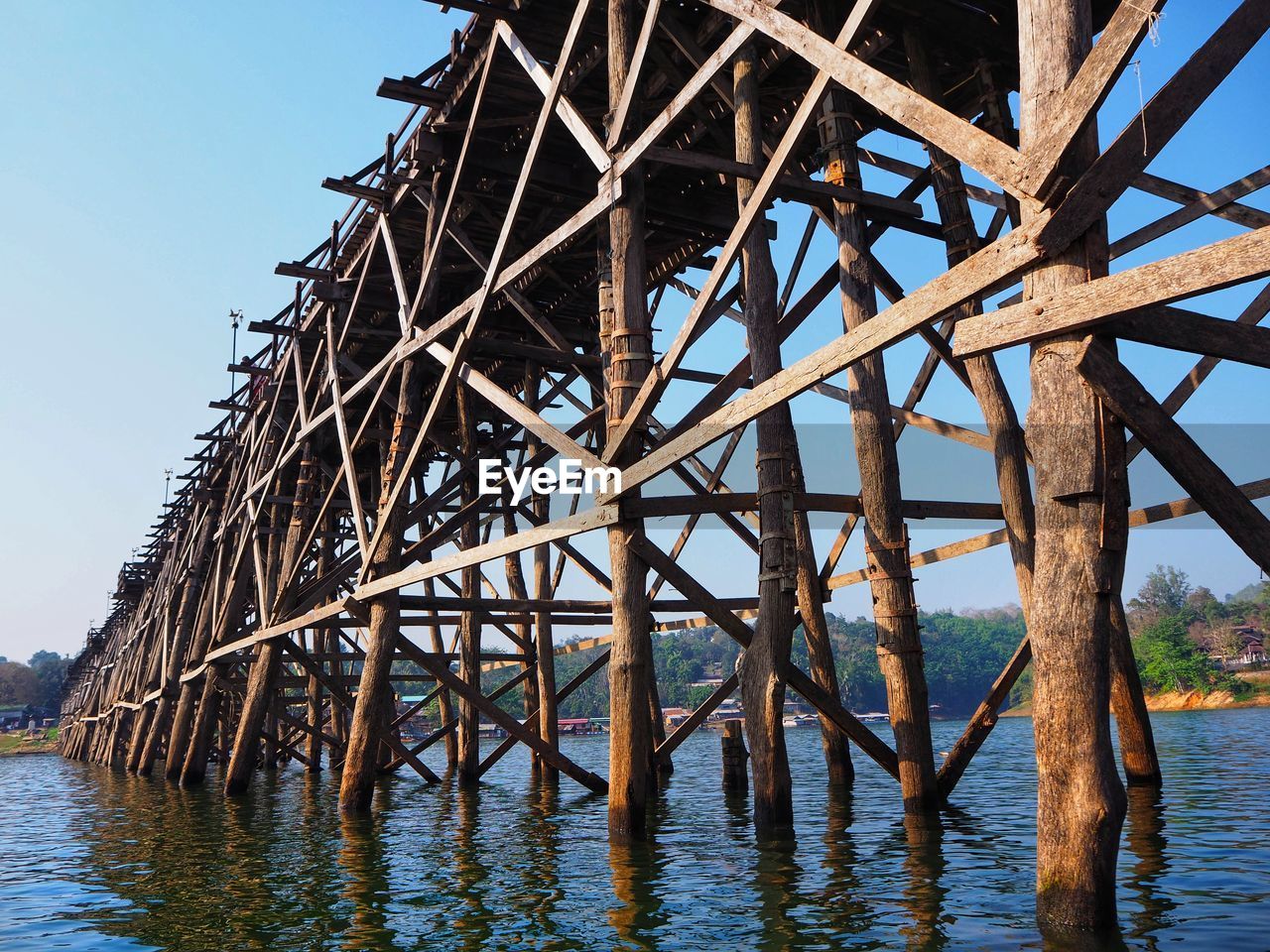 Low angle view of pier over sea against sky