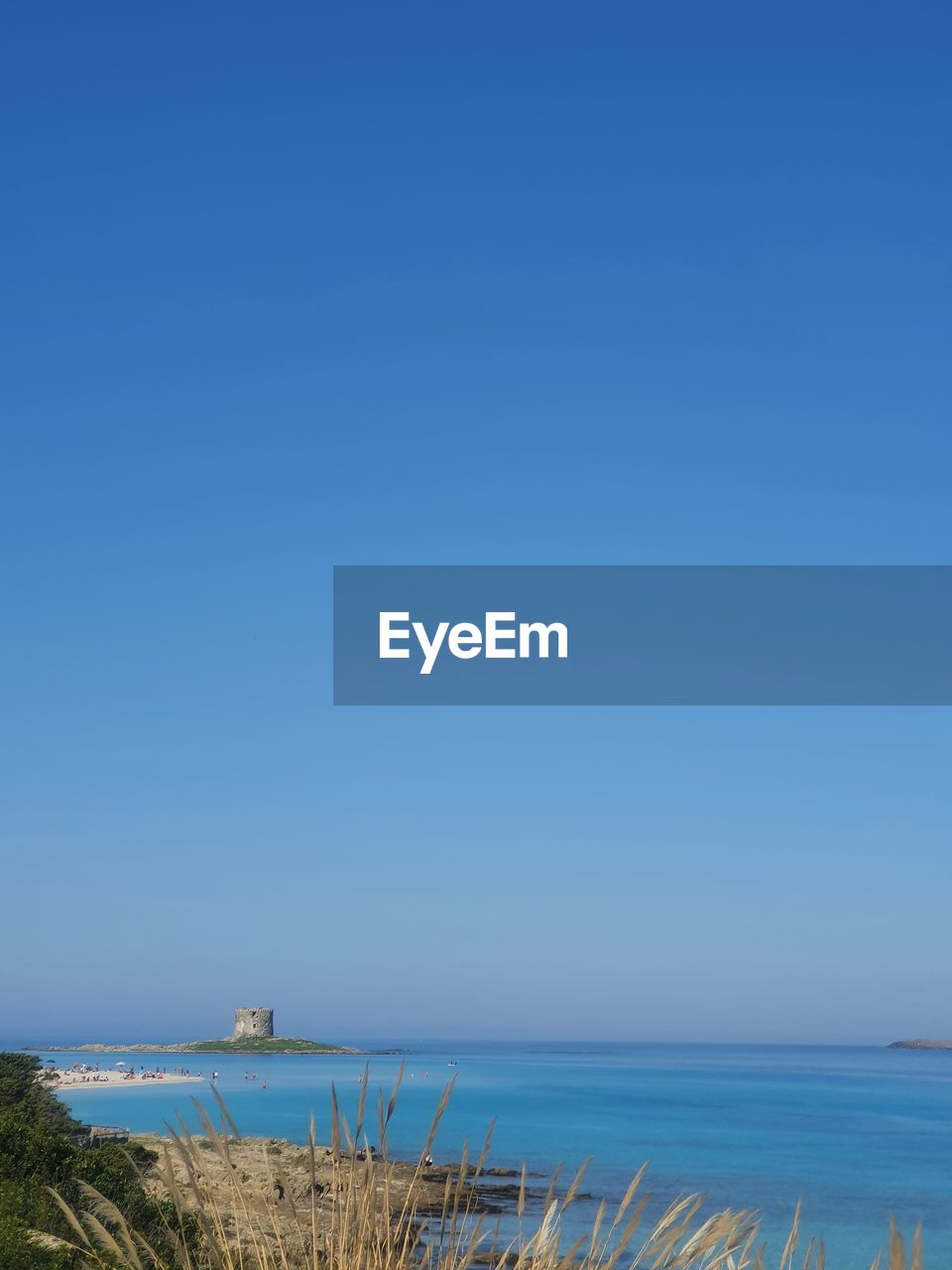 Scenic view of sea against clear blue sky