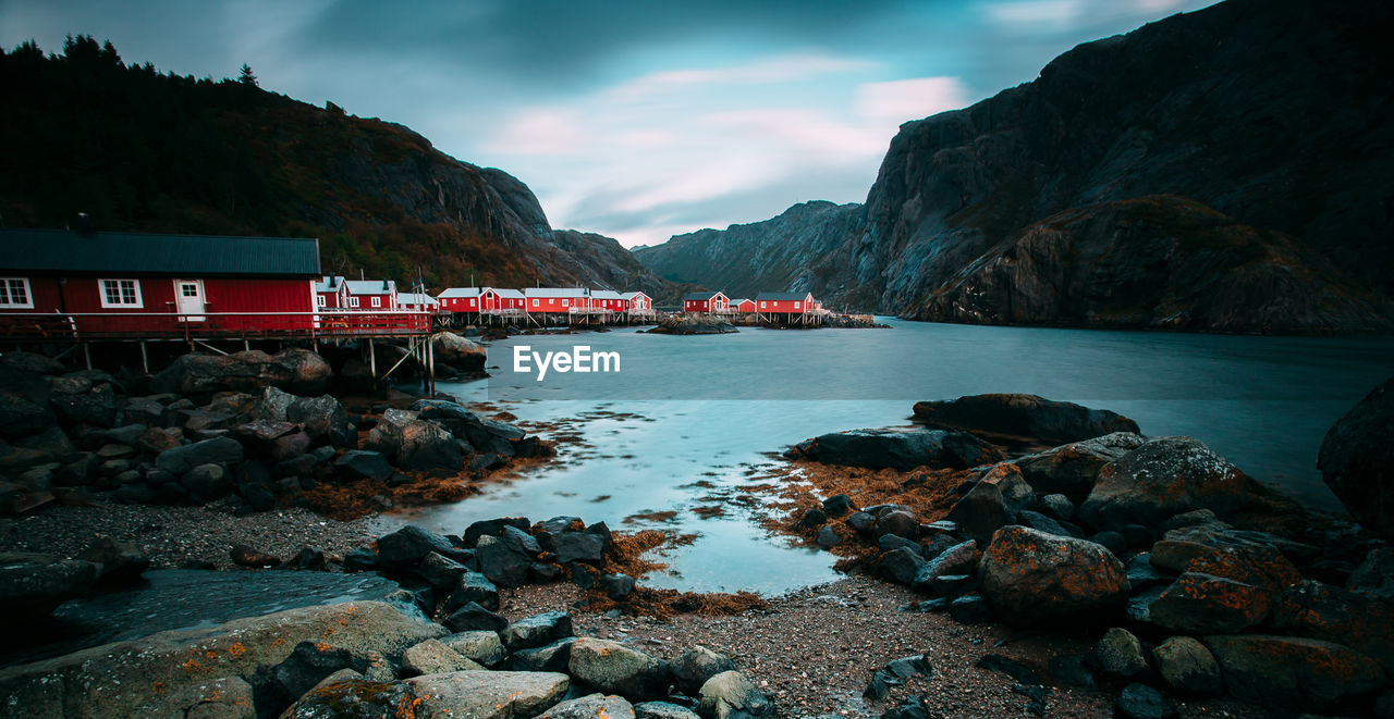 Scenic view of sea and mountains against sky