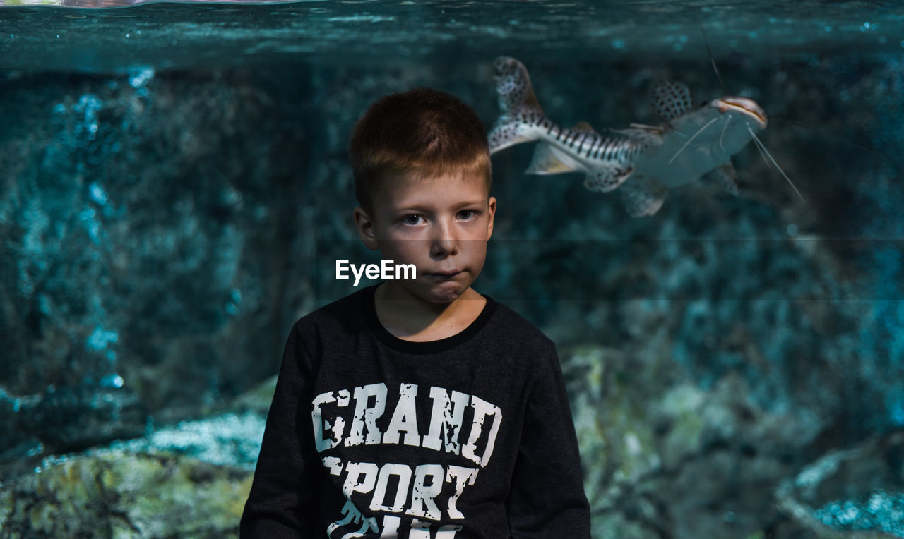 PORTRAIT OF BOY LOOKING DOWN