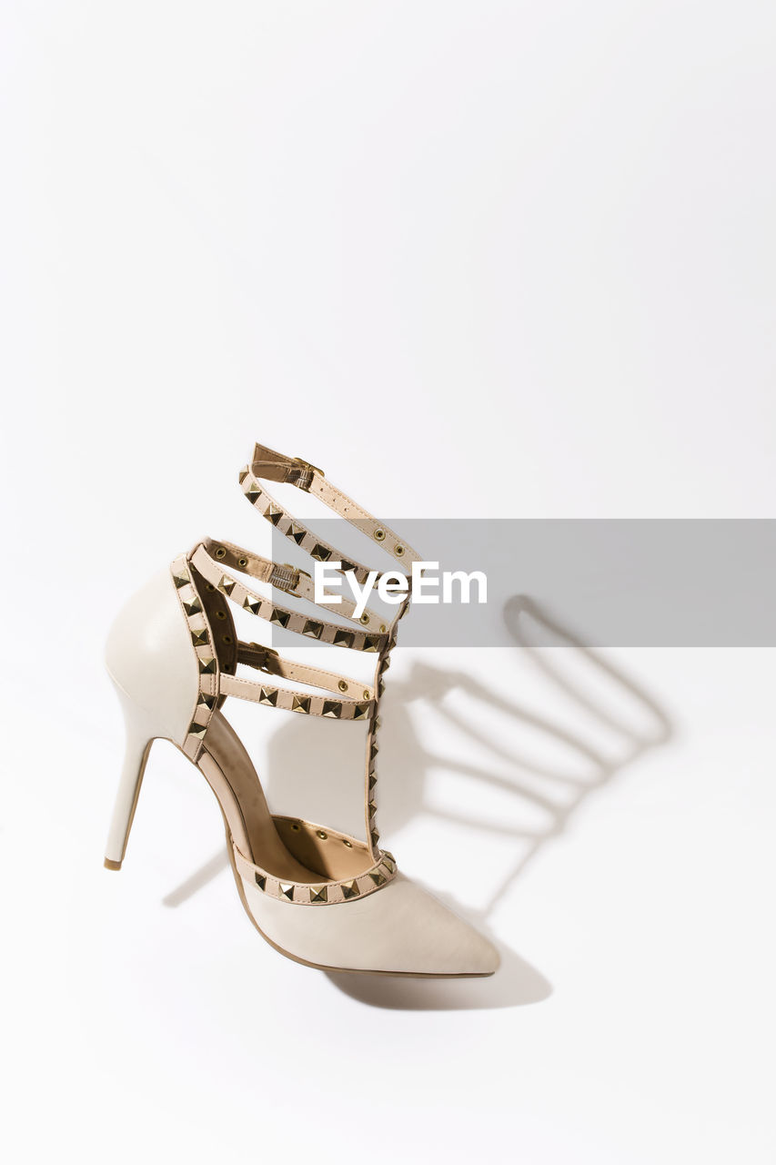Close-up of high heels against white background