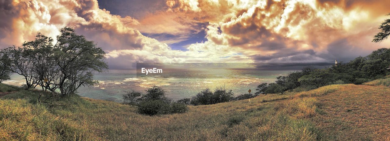 PANORAMIC SHOT OF SEA AGAINST LANDSCAPE