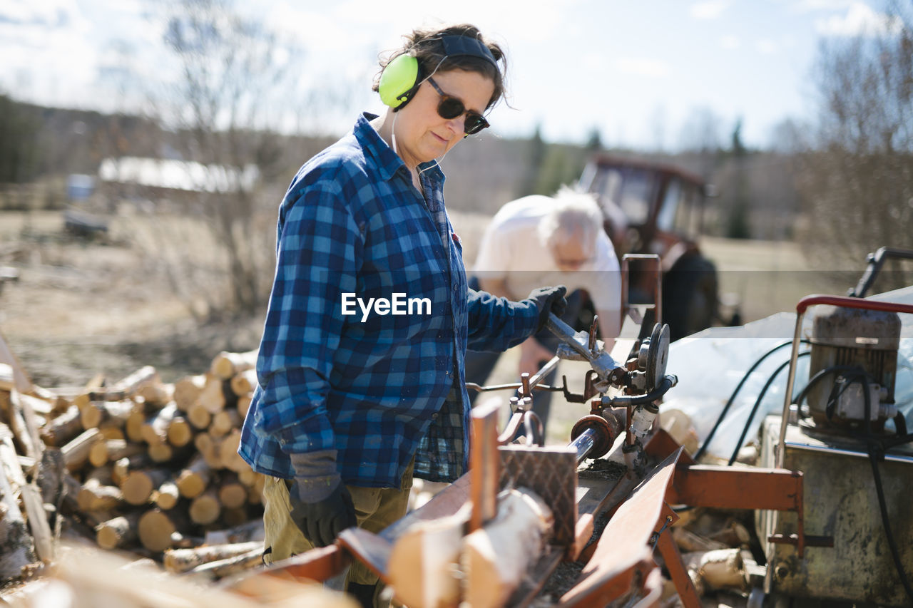 Mature woman working in sawmill