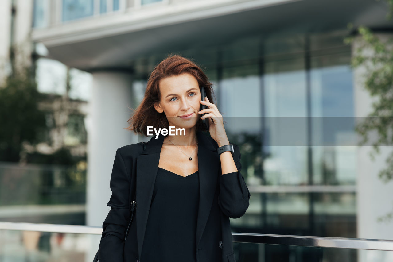 businesswoman talking on mobile phone in city