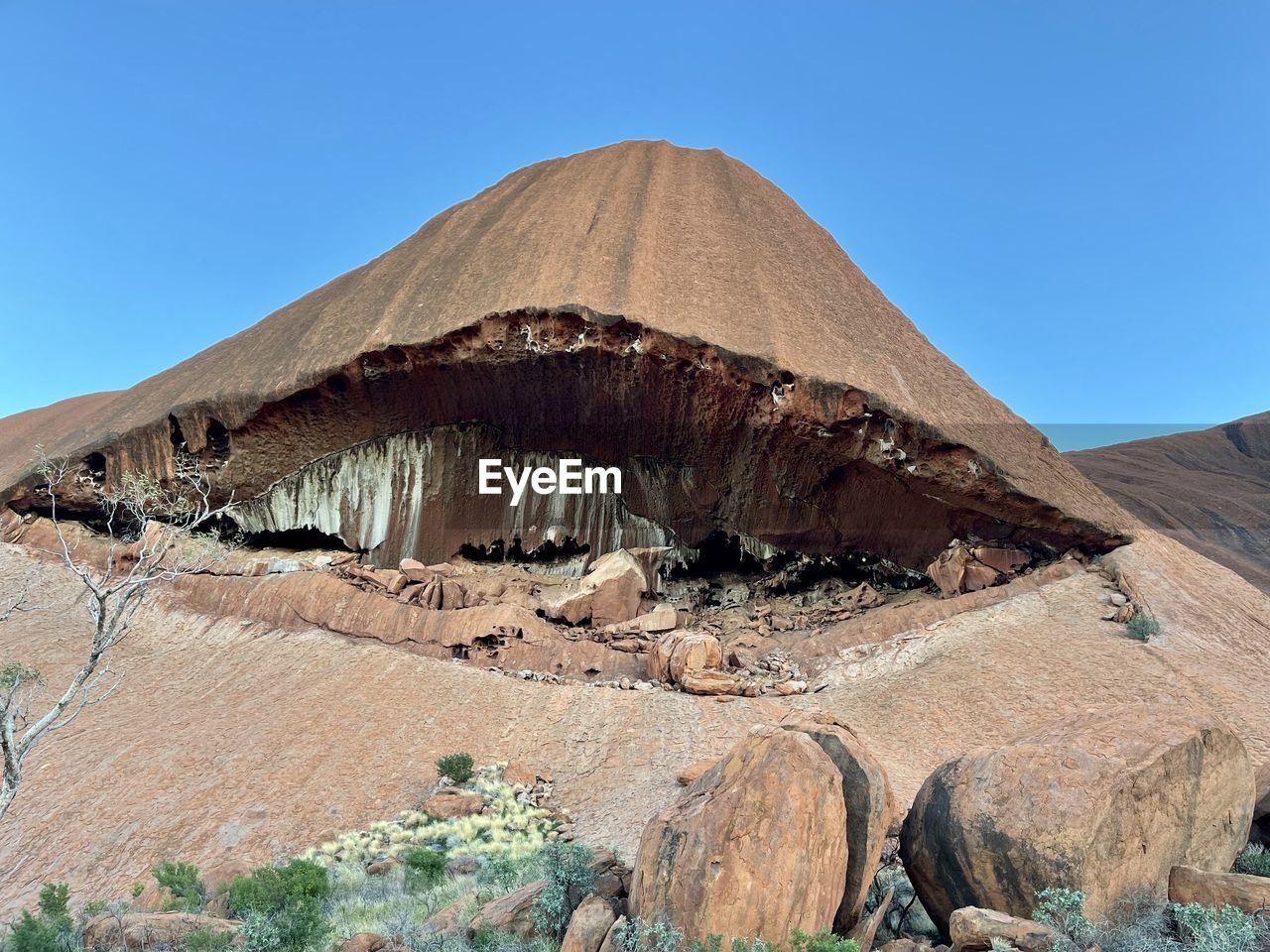 Rock formations on mountain against clear blue sky