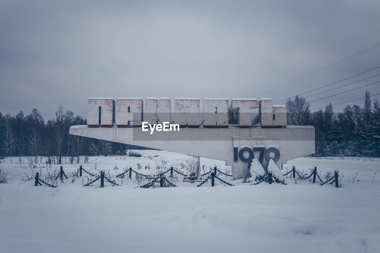 SNOW COVERED LAND AGAINST SKY