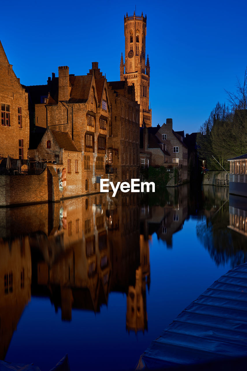 Reflection of buildings in the canal of brugge in belgium