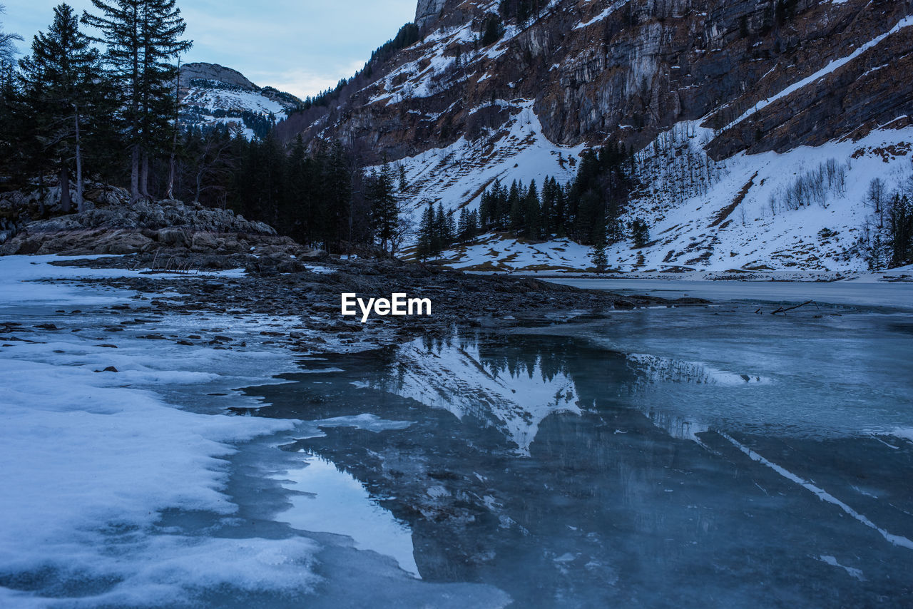 Scenic view of frozen lake against sky during winter