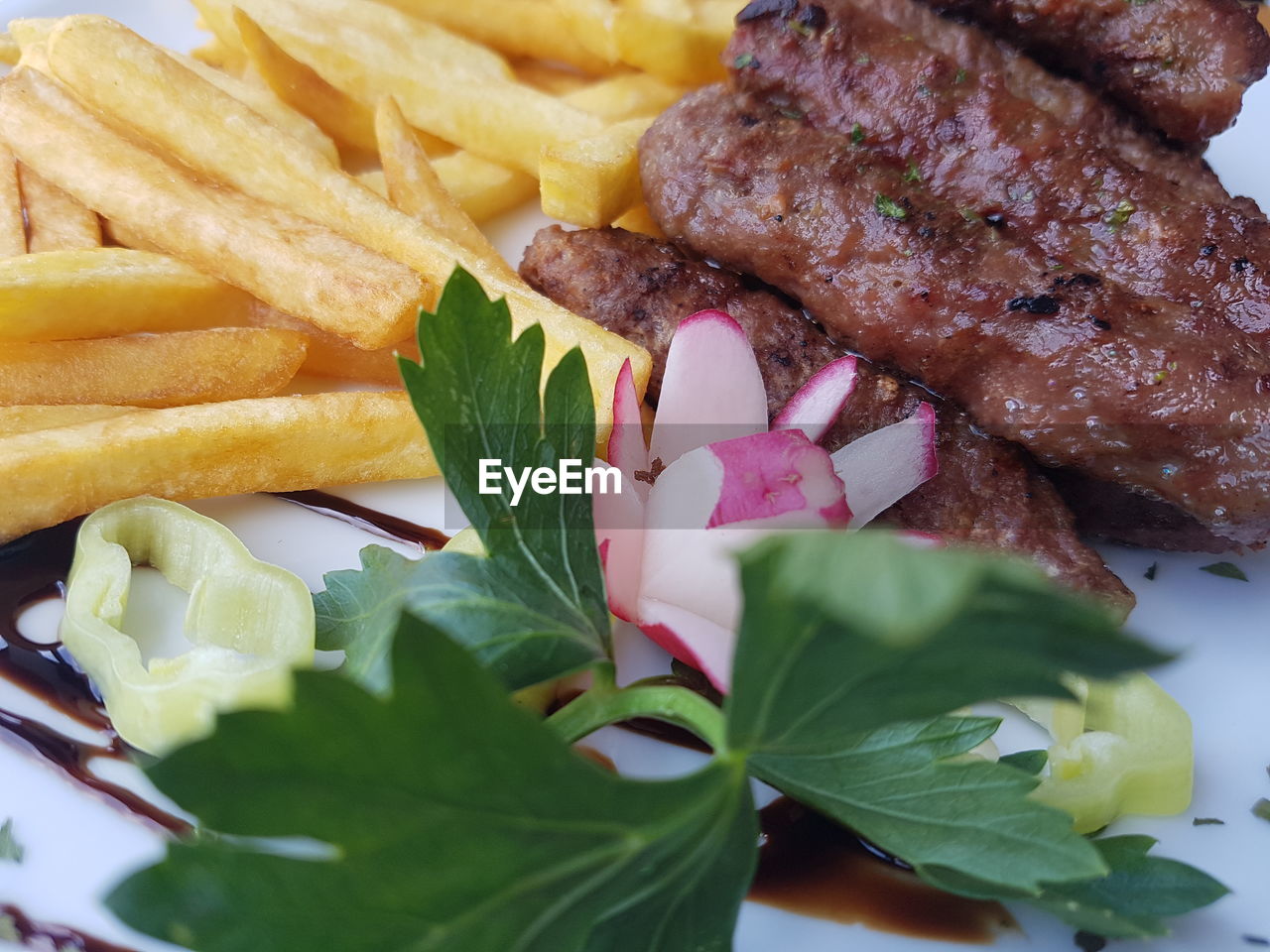 Close-up of meat and french fries served in plate