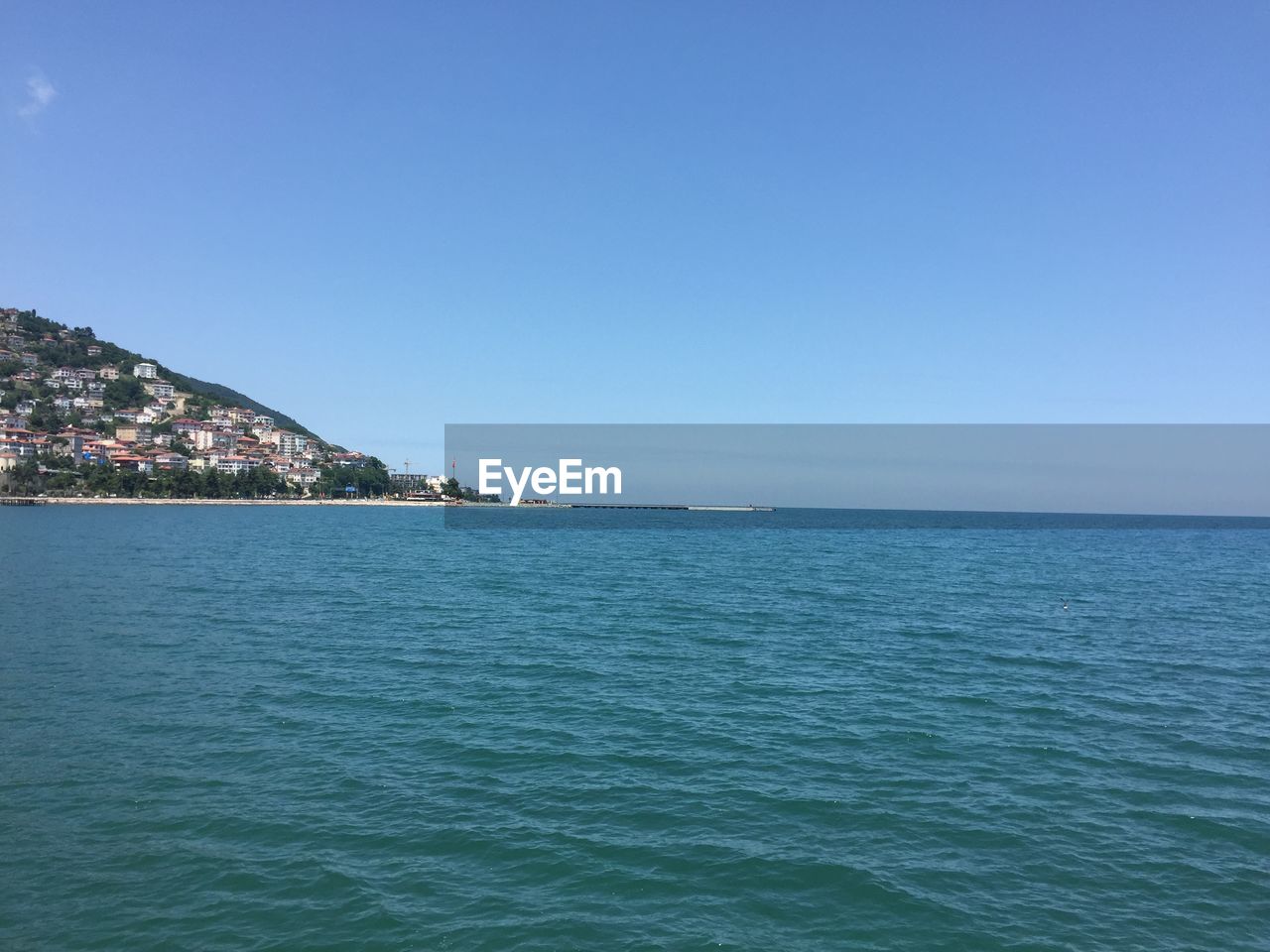 Scenic view of sea against clear blue sky