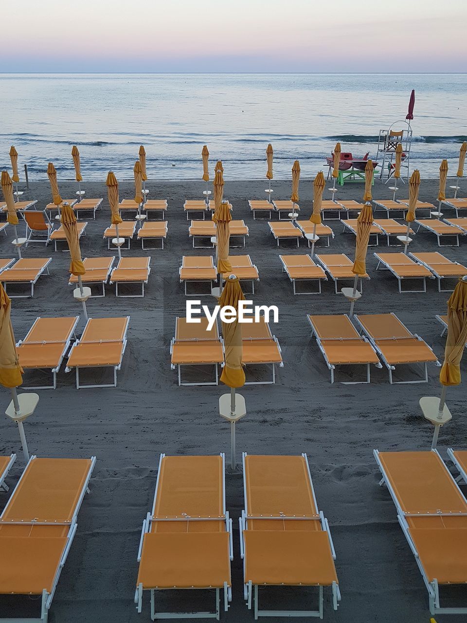 ROW OF CHAIRS ON BEACH