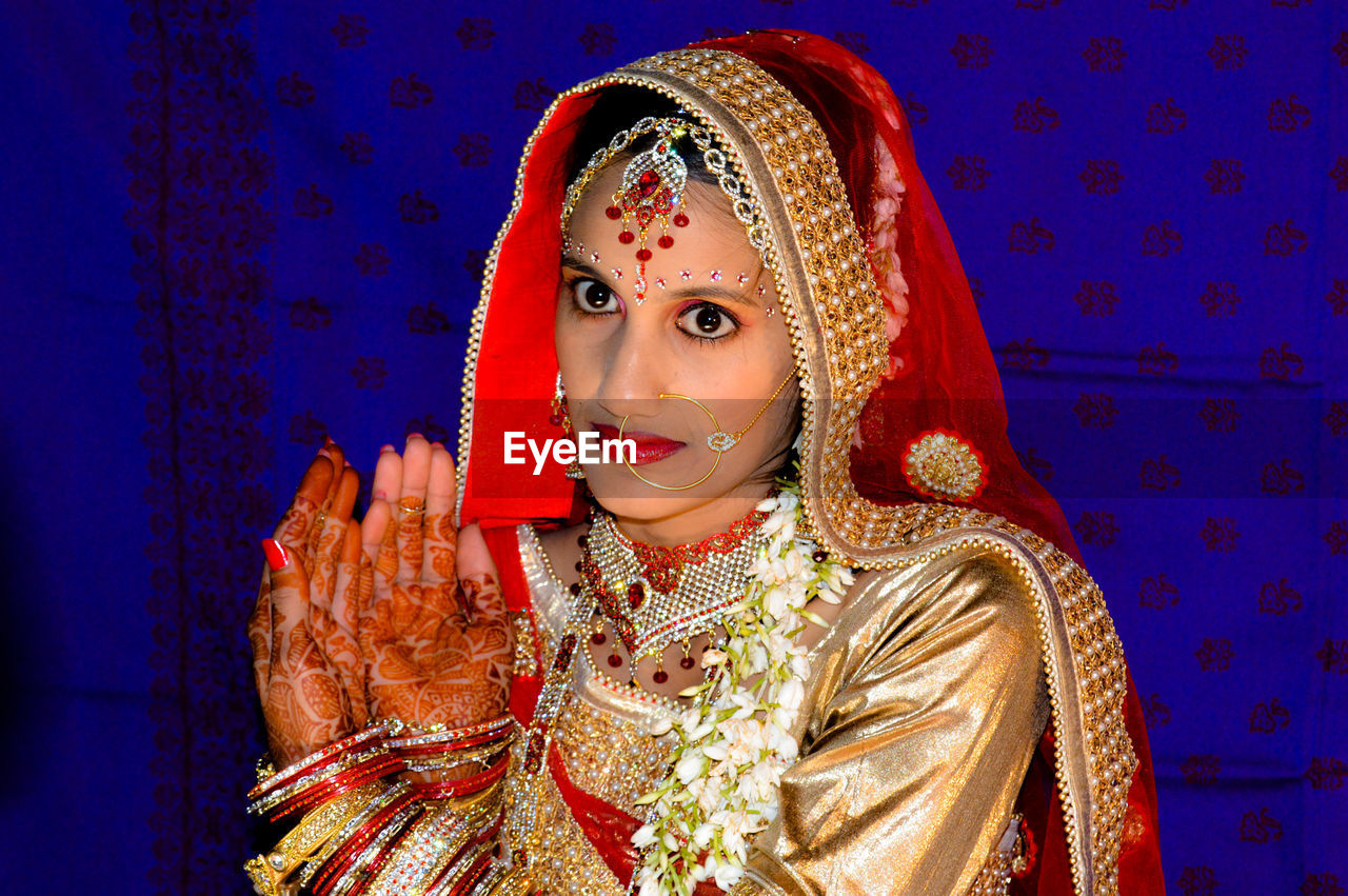 Young bride showing henna tattoo during wedding