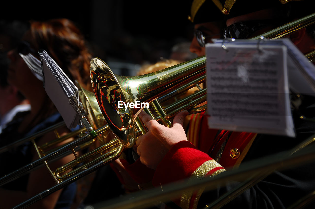 Midsection of men playing trumpets