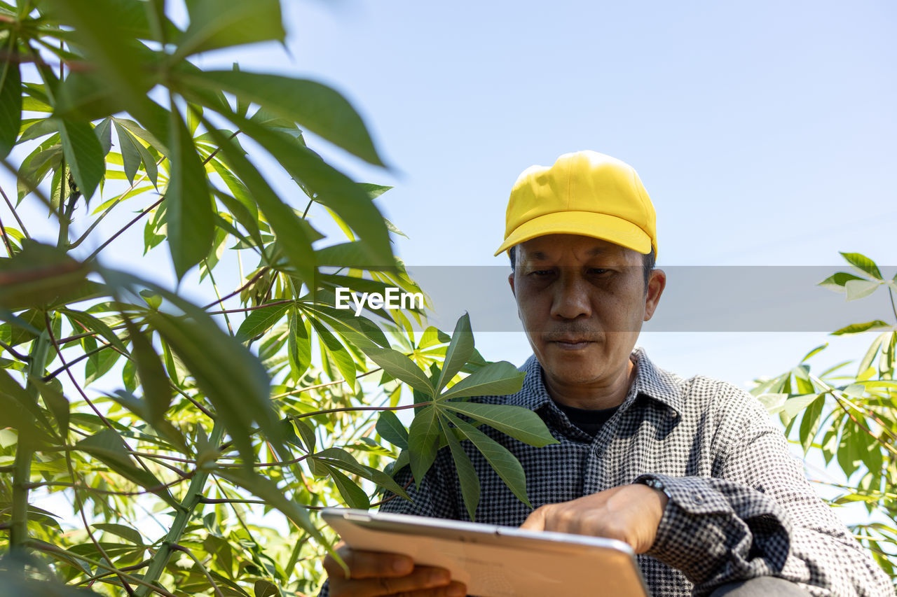 PORTRAIT OF MAN WORKING ON PLANT