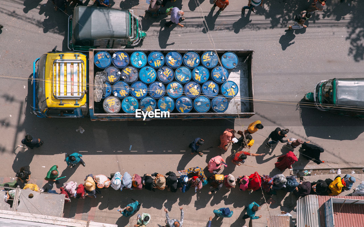 High angle view of people waiting in a line to get vaccine on street