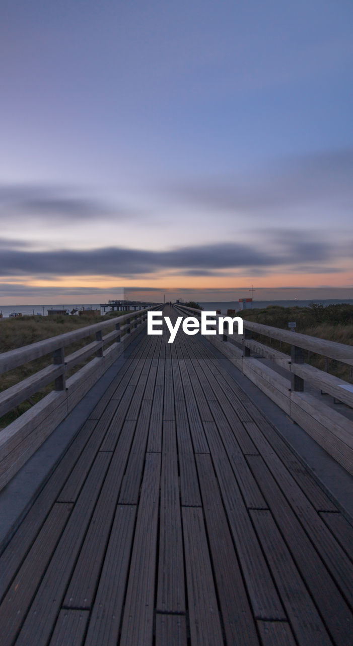 SURFACE LEVEL OF BOARDWALK AGAINST SKY