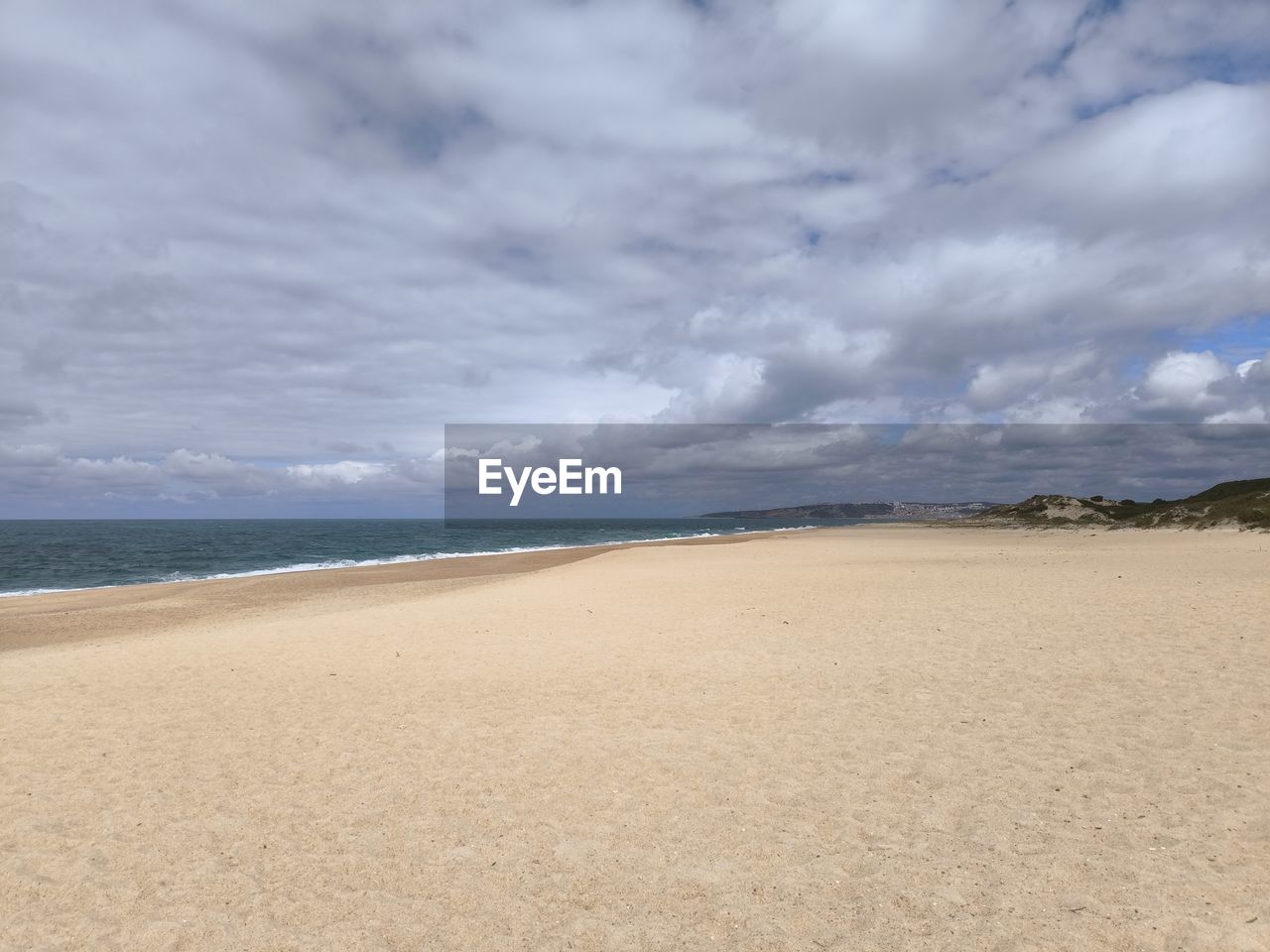 land, sky, beach, sea, sand, water, cloud, scenics - nature, environment, landscape, beauty in nature, nature, dramatic sky, water's edge, tranquility, travel destinations, coastline, coast, sand dune, body of water, travel, shore, horizon, tranquil scene, tourism, seascape, storm, cloudscape, non-urban scene, no people, holiday, overcast, outdoors, trip, vacation, summer, animal wildlife, day, horizon over water, dune, absence, natural environment, desert, awe, nature reserve, blue, storm cloud, ocean, wet, urban skyline, idyllic, tide, wave, pattern, accidents and disasters, coastal feature, sunlight