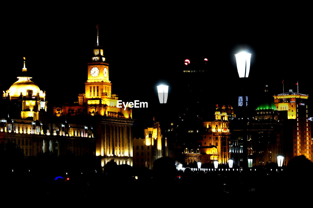 Illuminated city against sky at night