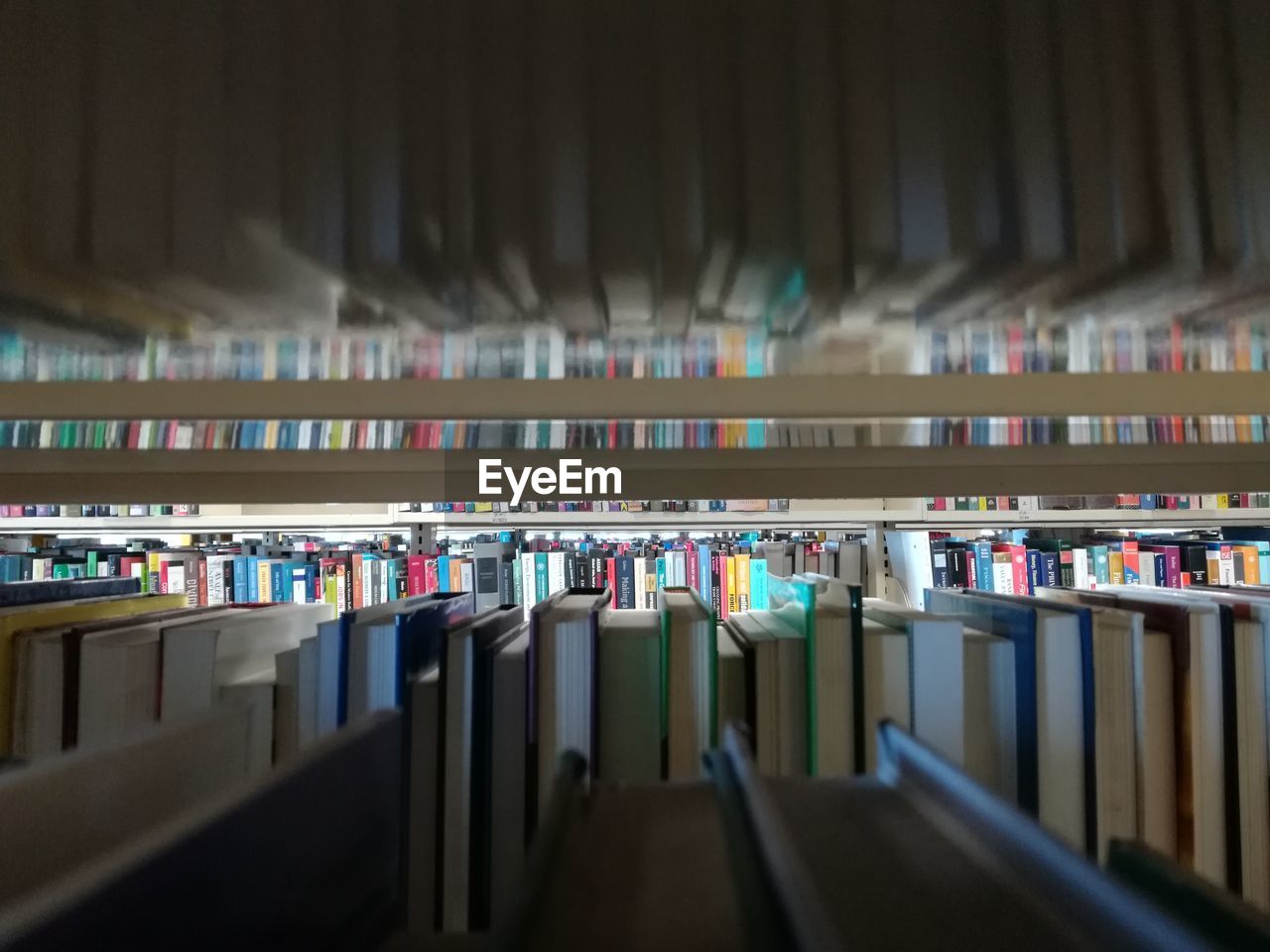Full frame shot of books arranged on shelves in library
