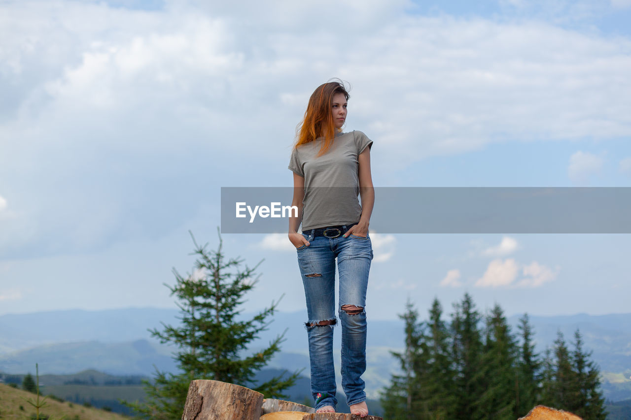 Girl posing and gesturing in the summer high in the carpathian mountains