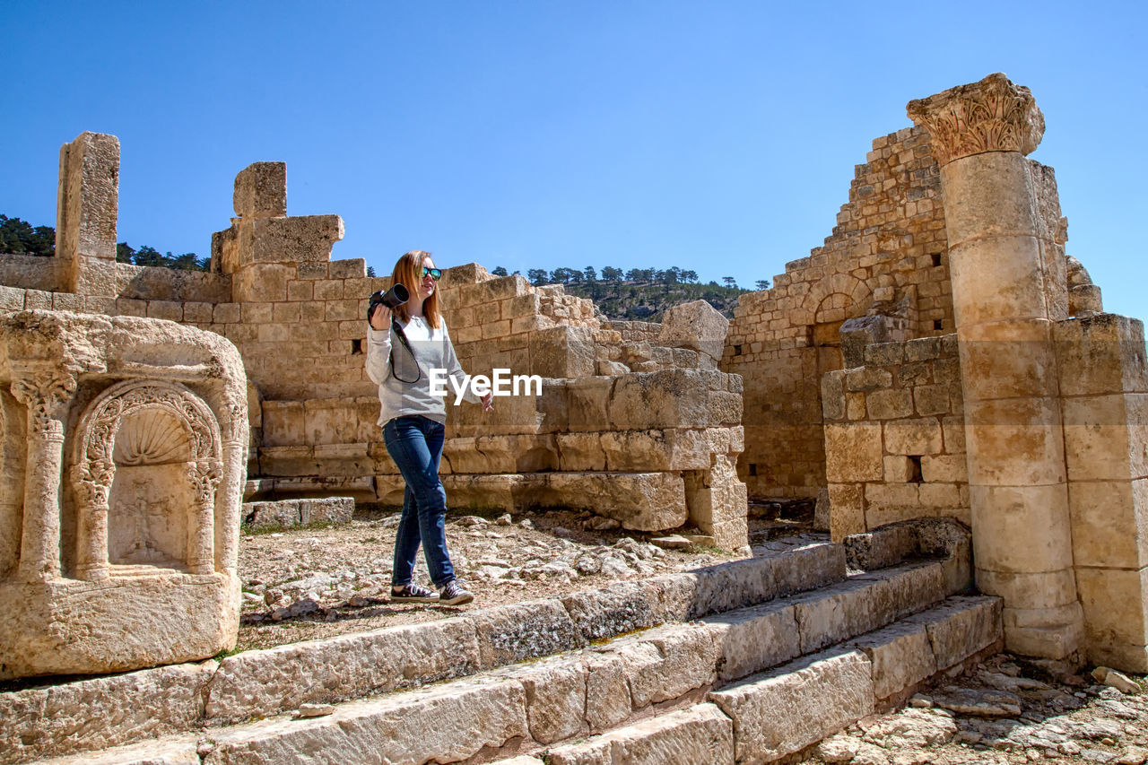 Full length of woman walking in old ruins