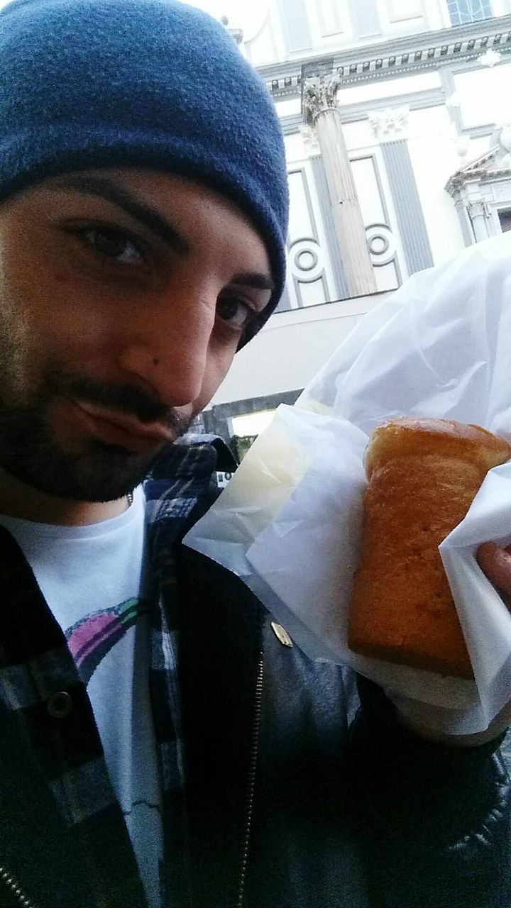 Close-up portrait of young man having food