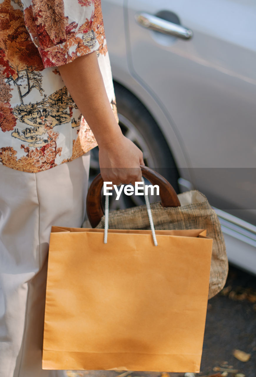 Woman holding the paper bag from shopping