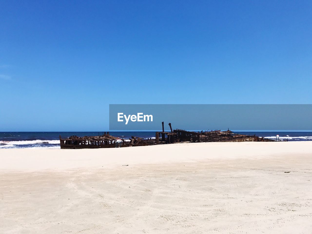 BEACH AGAINST CLEAR BLUE SKY