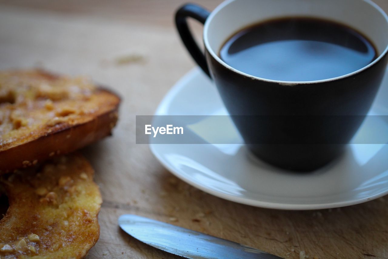 CLOSE-UP OF CUP OF COFFEE WITH SPOON AND DRINK