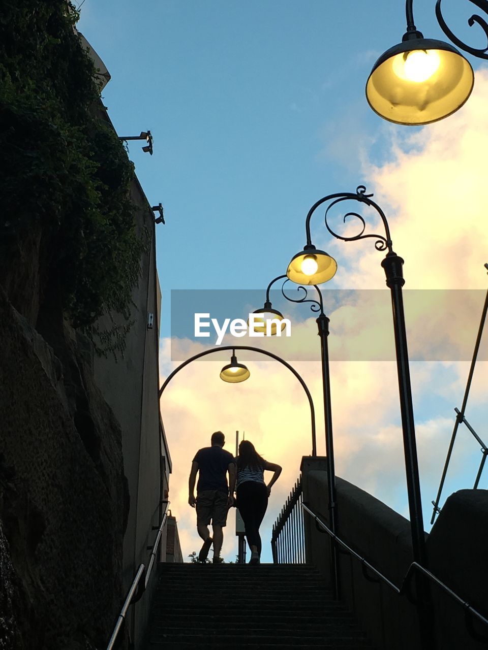 LOW ANGLE VIEW OF PEOPLE WALKING ON STEPS