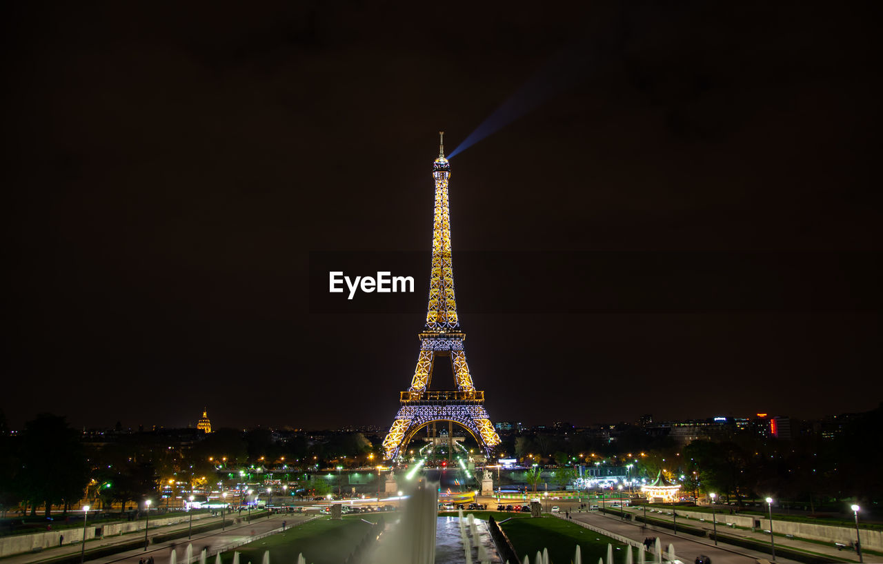 ILLUMINATED BUILDINGS IN CITY AT NIGHT