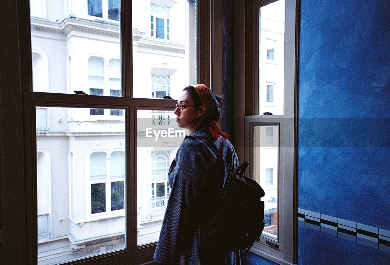 Woman standing by window