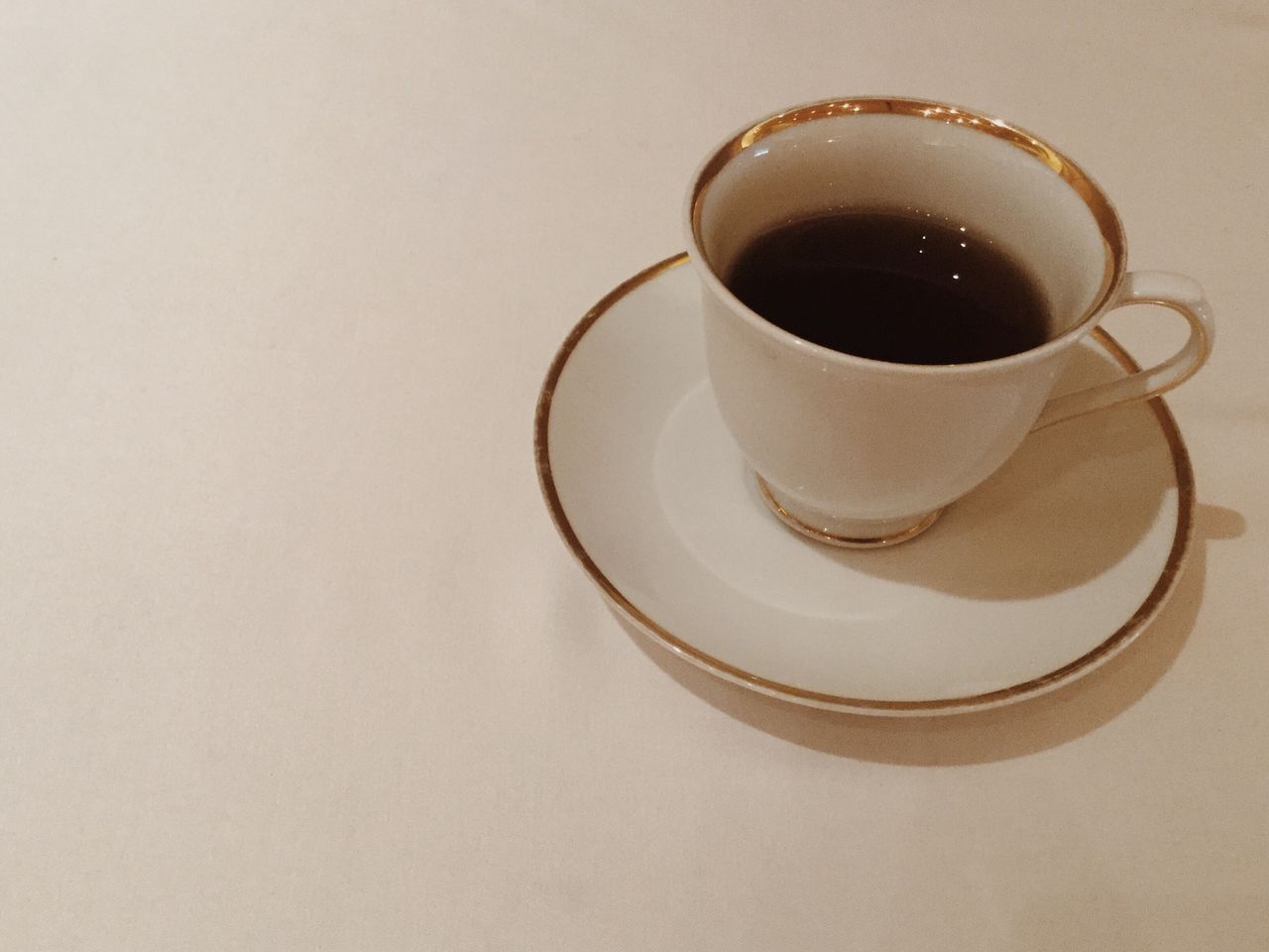 CLOSE-UP OF COFFEE ON TABLE