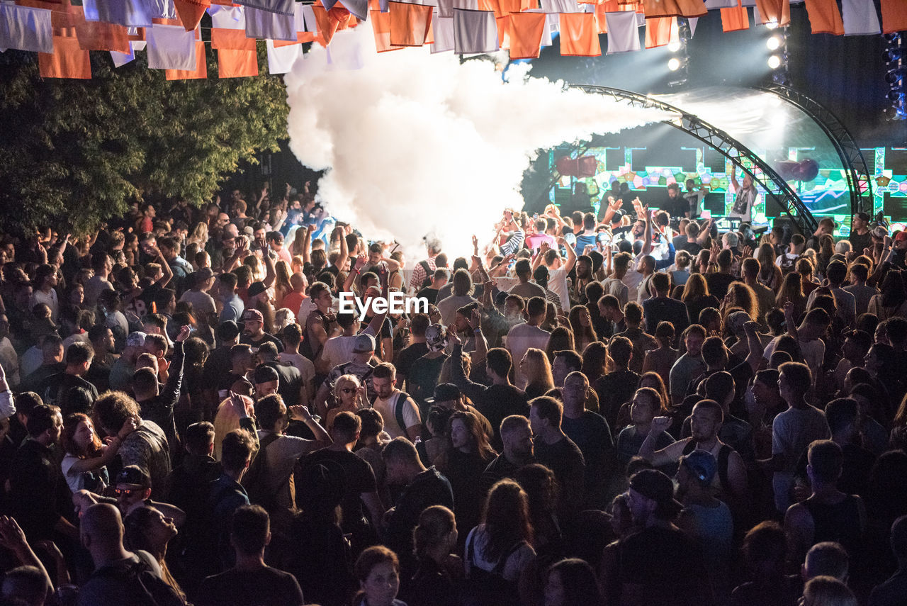 People enjoying music concert at night